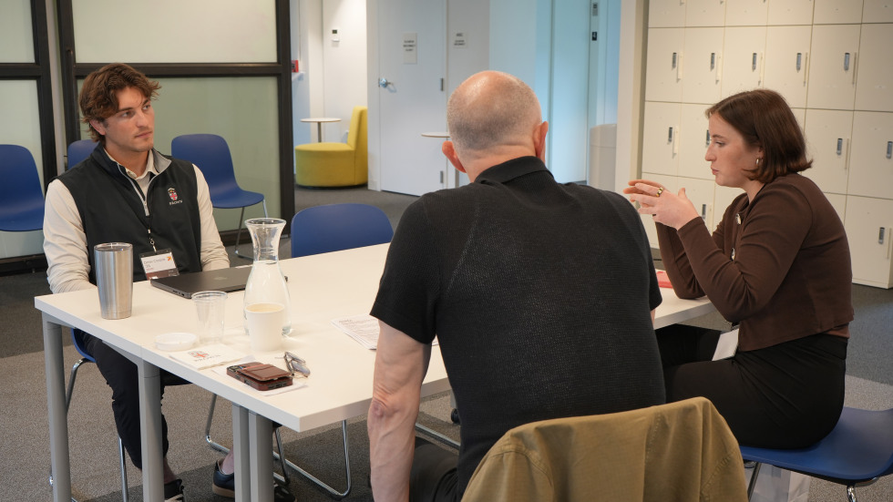 Student discussing venture with mentors at Mentor Roundtable