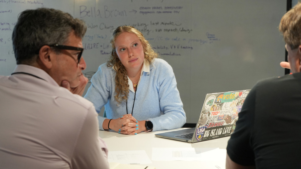 Student discussing venture with mentors at Mentor Roundtable